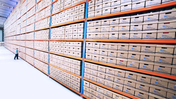 Wide shot of a wholesale warehouse with a worker in the distance