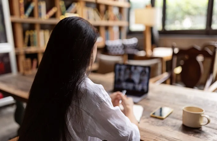 Woman working remotely from cafe