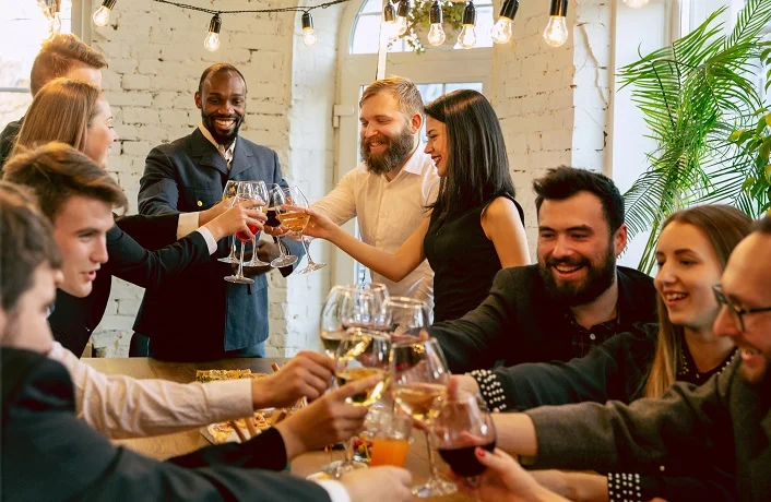 Co-workers or networkers celebrating around a table