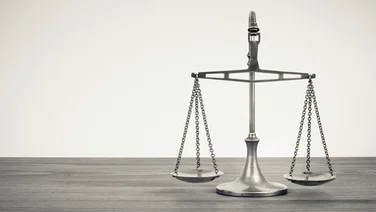 silver balancing scales on a desk
