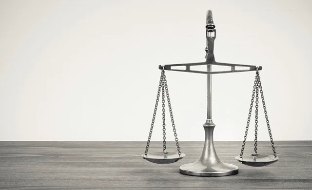 silver balancing scales on a desk