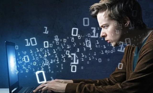 Man at computer screen with coding graphics around him