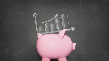 pink piggy bank against black background with a graphic of increasing piles of money on its back