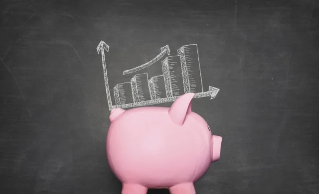 pink piggy bank against black background with a graphic of increasing piles of money on its back