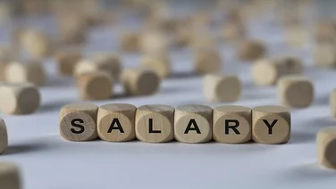 wooden blocks spelling out salary