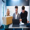 Women with packaging, talking to colleagues