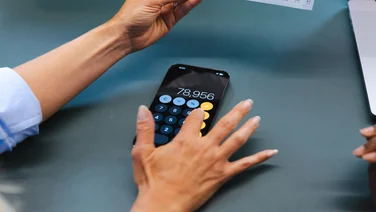 A person types on a calculator app