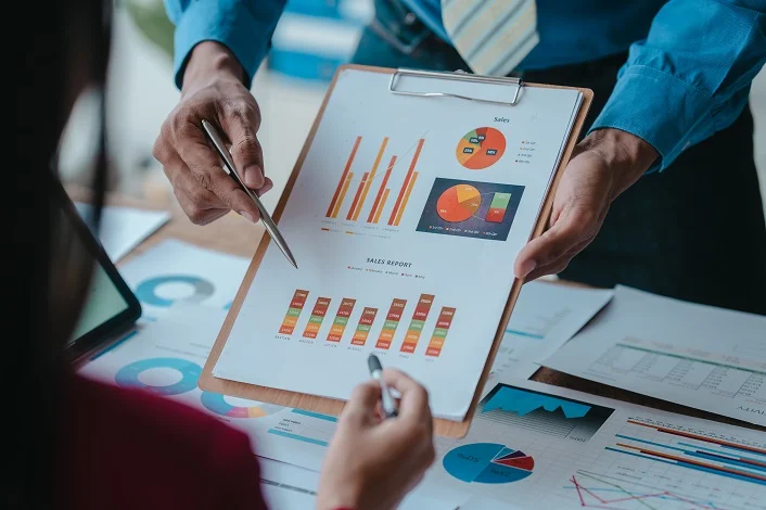 Close up bookkeepers working with balance sheet to analyze problems and find solutions to bringing develop business organization and company's stock market system. Common stock and preferred stock.