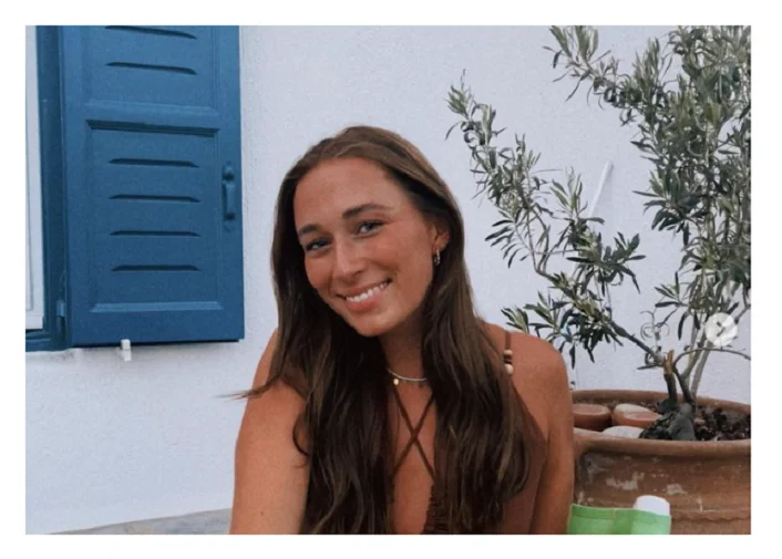Image of a young woman smiling whilst on holiday, taken from Instagram