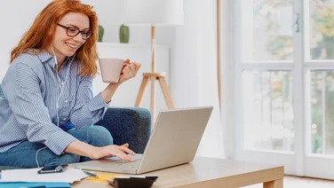 Young woman using notebook and working at home
