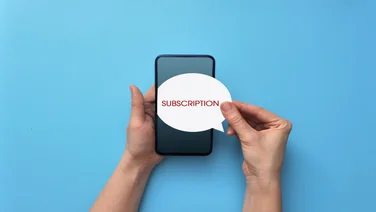 Hands holding a speech bubble saying "subscription" over a phone on a blue background