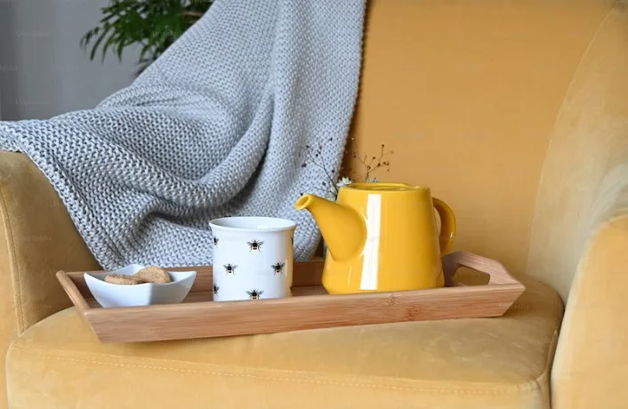 Picture of a yellow teapot on a yellow chair
