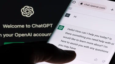 ChatGPT chat bot screen seen on smartphone and laptop display wi