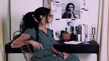 A woman staring into space in her office