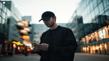 A man in the street browsing his phone