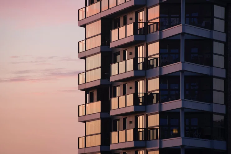 A close-up image of a block of flats at sunset
