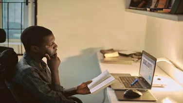 a man learning online via his laptop