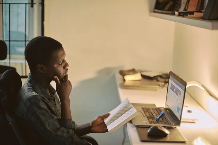a man learning online via his laptop