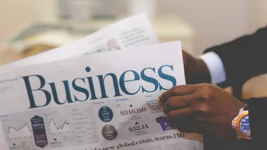image of a businessman holding the financial papers