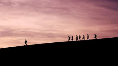 a leader leading a group across a landscape