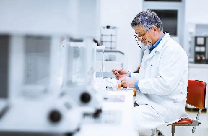 Senior male researcher carrying out scientific research in a lab