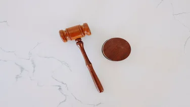 a top-down image of a gavel on a marble worktop