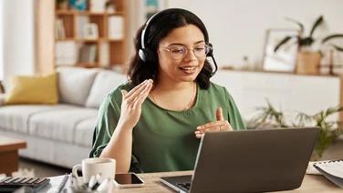 Home customer support, laptop video call and woman explain consultation, ecommerce or sales pitch in webinar. Freelance, remote work receptionist or person consulting on online conference discussion.