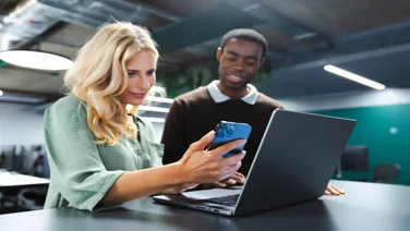 Group of people looking at a business phone