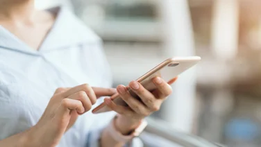 woman using smartphone on staircase in public areas, During leisure time. The concept of using the phone is essential in everyday life.