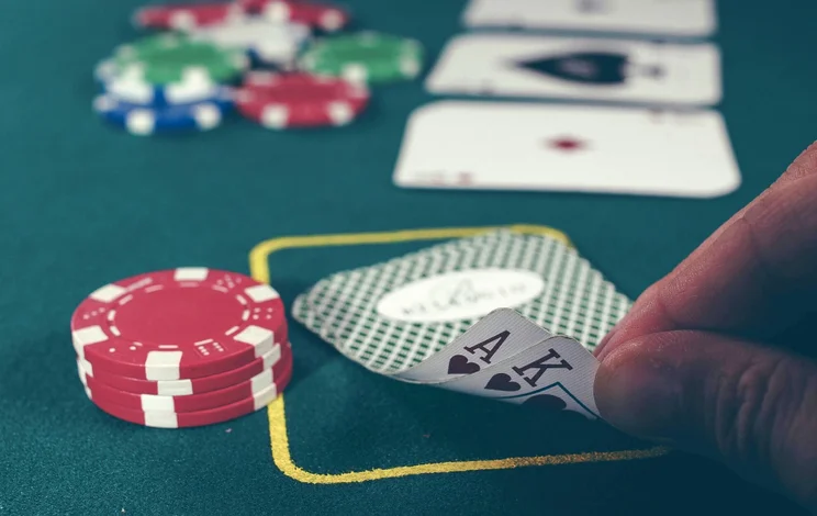 a card player peeks at their hand