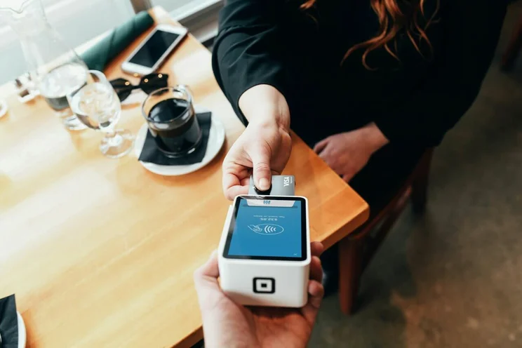 Customer paying by card at a cafe