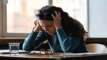a woman struggling with stress at her desk