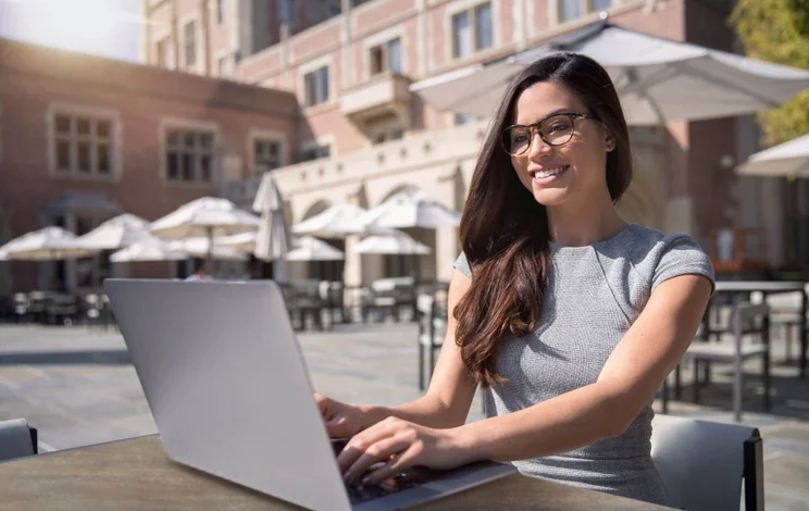 Woman working at a cafe outdoors abroad