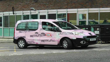 Pink PrettyLittleThing van on road