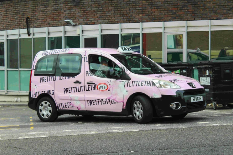 Pink PrettyLittleThing van on road