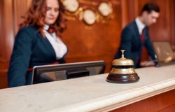 A hotel staff member at the front desk.
