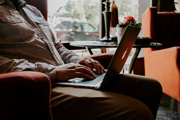 Self-employed person working on laptop at home desk