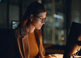 a female business founder sitting at her computer.