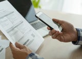 A person paying an invoice with their phone.